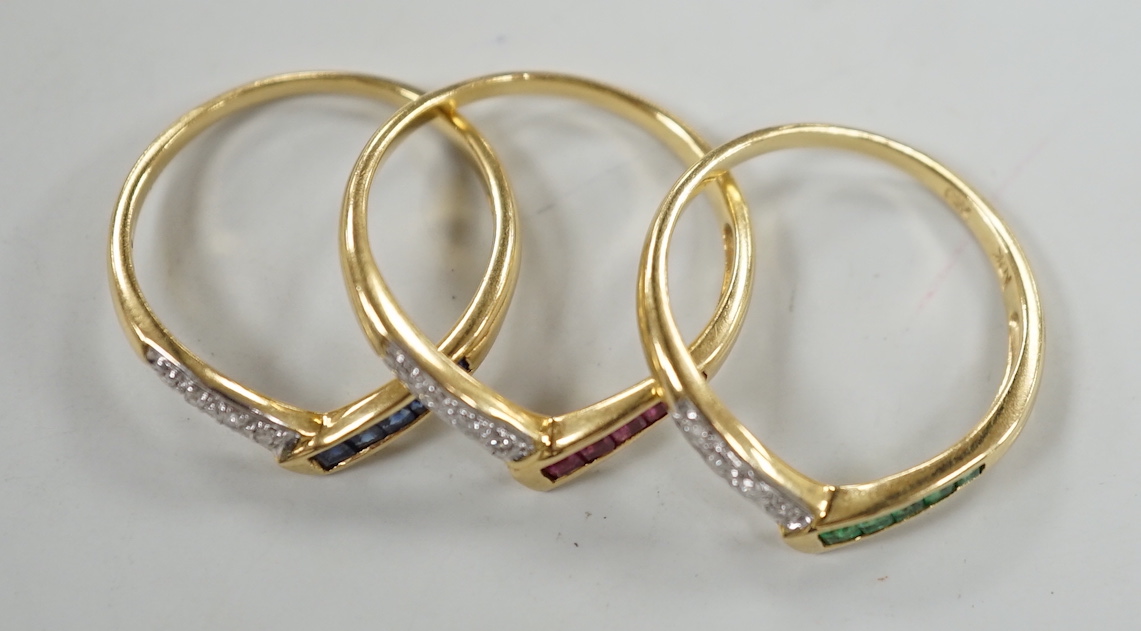 A set of three 750, sapphire, emerald and diamond set wishbone rings, (to be worn as one or singularly), size M/N, gross weight 5.4 grams.